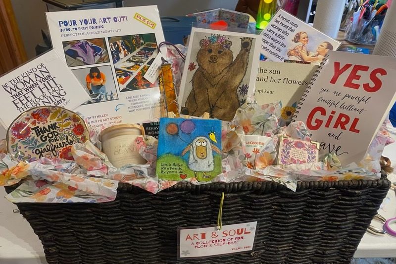 A Happy Marmot gift basket full of art, cards, and suncatchers