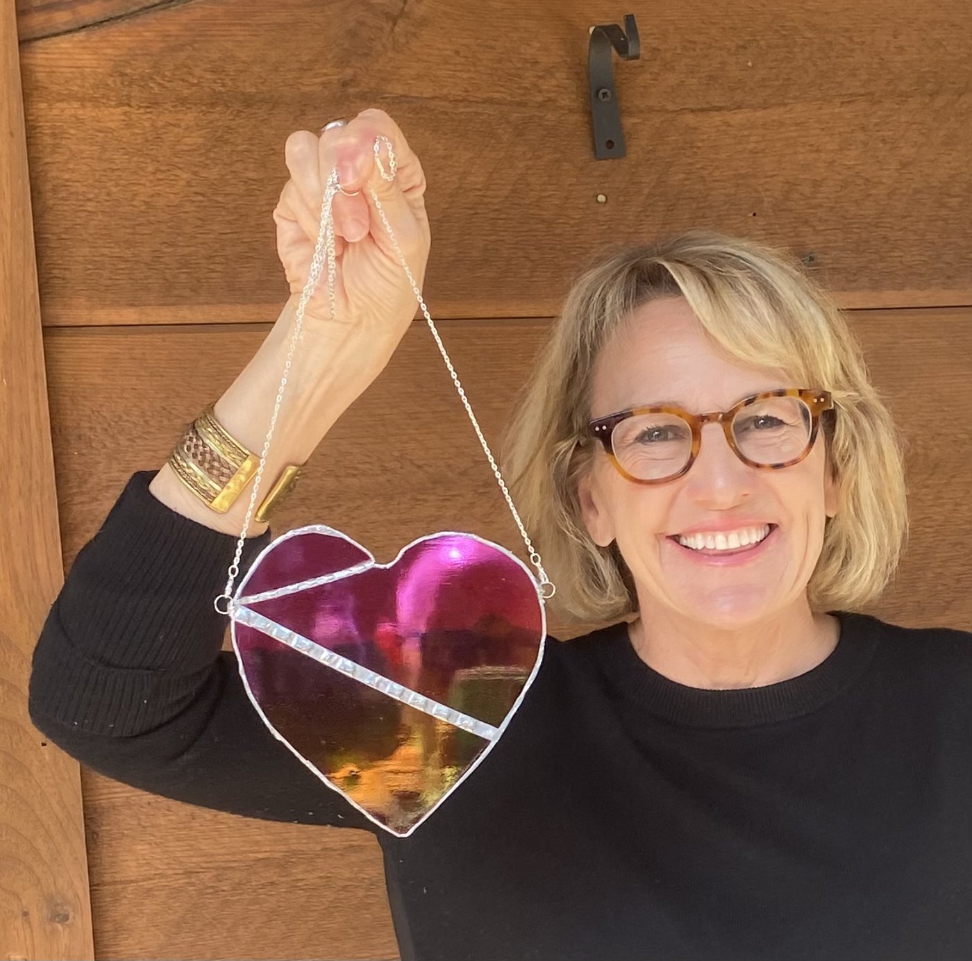PJ holding a pink stained glass heart